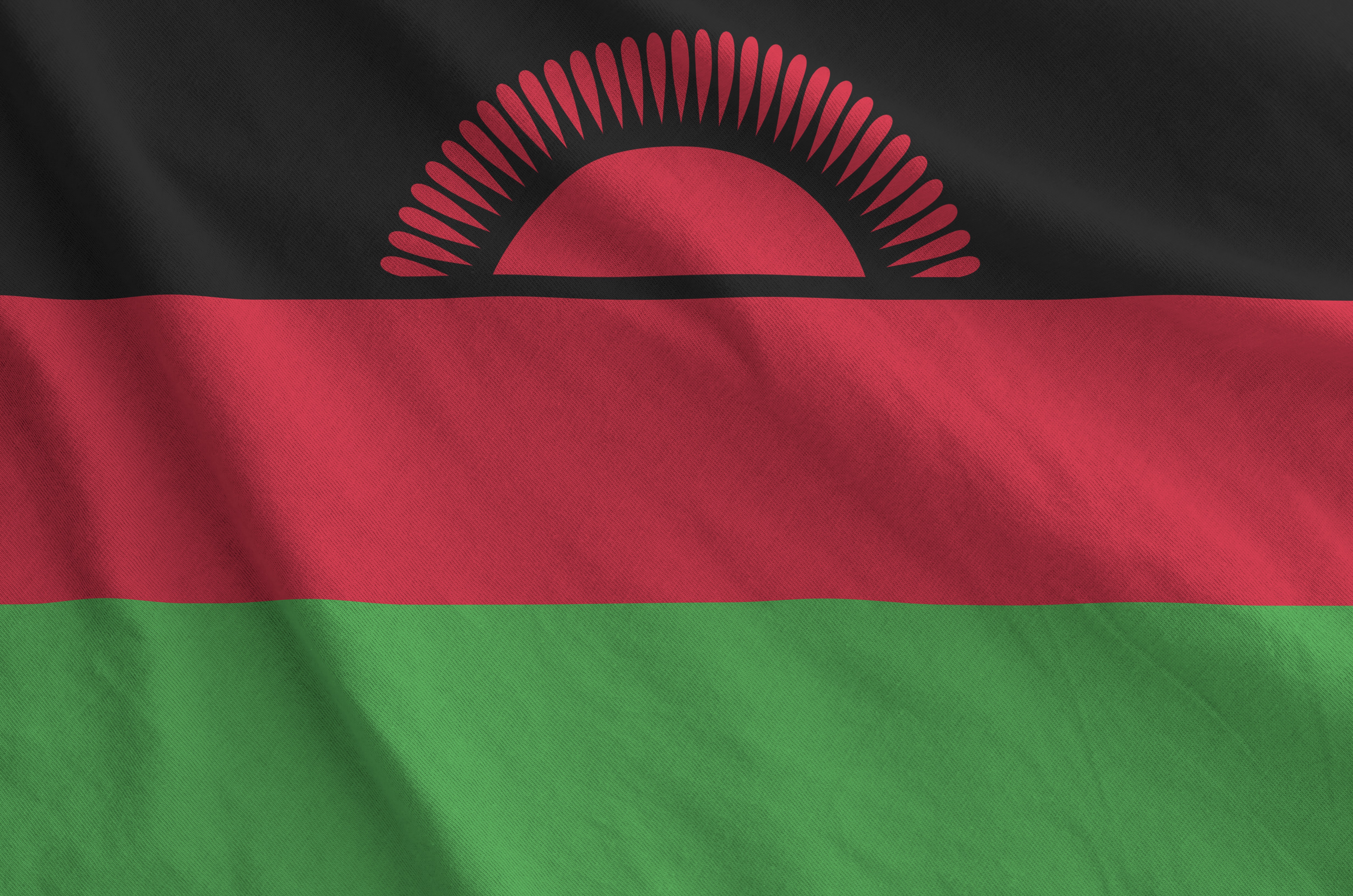 Malawi flag depicted on folded wavy fabric of old cloth